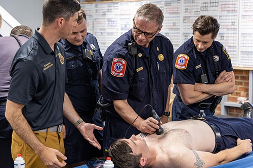 fire fighters training with patient on table