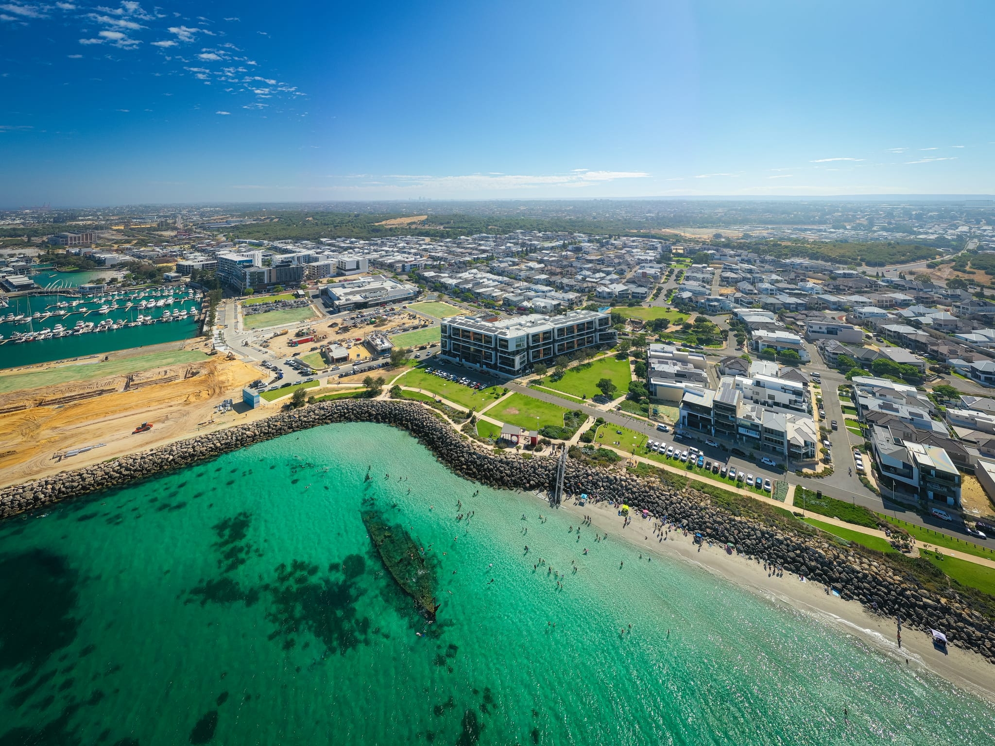 coastal city with people  along the beach shoreline